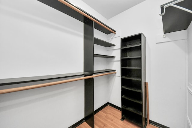 walk in closet featuring light hardwood / wood-style flooring