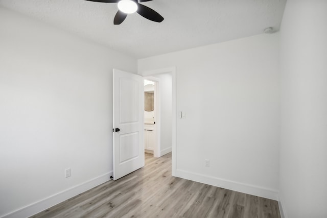 empty room with light wood-type flooring and ceiling fan