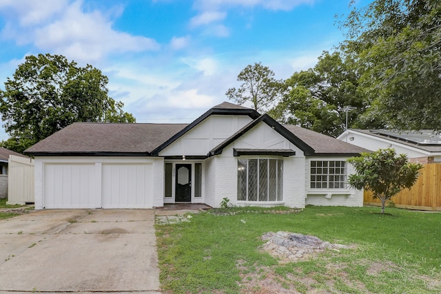 view of front of property featuring a front lawn and a garage