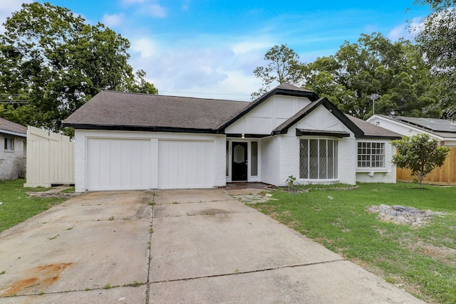 view of front of home featuring a front lawn and a garage