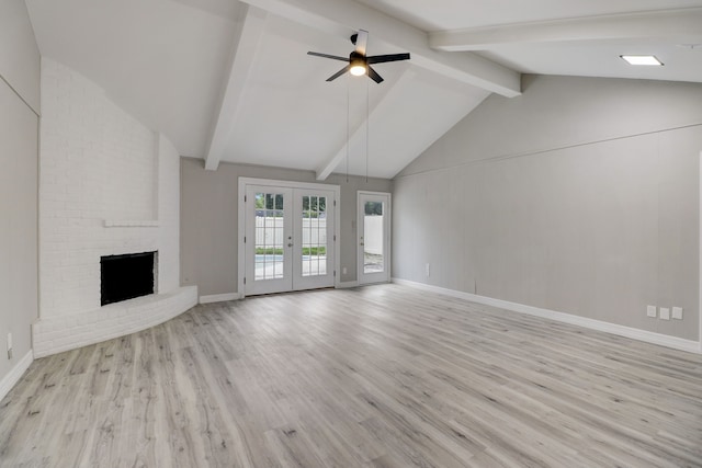 unfurnished living room with french doors, light hardwood / wood-style flooring, vaulted ceiling with beams, and a fireplace