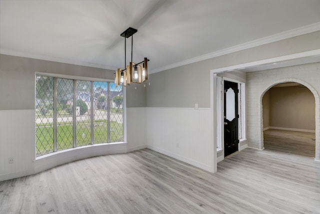 unfurnished dining area featuring light hardwood / wood-style flooring and crown molding