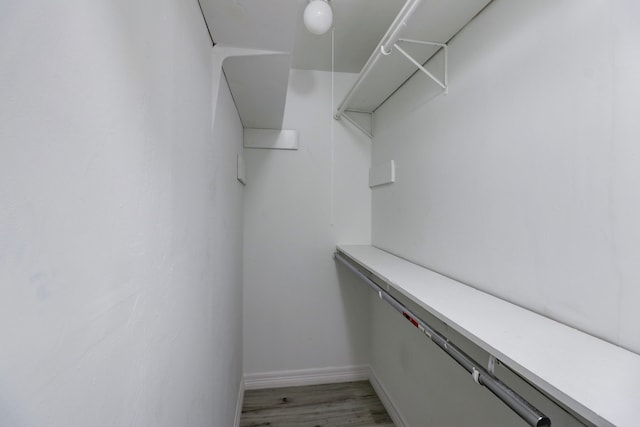 walk in closet featuring light hardwood / wood-style flooring