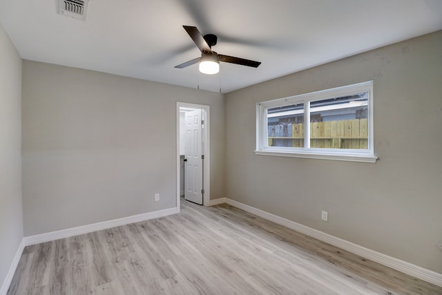 spare room with light wood-type flooring and ceiling fan