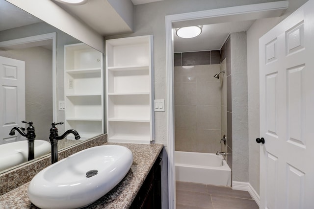 bathroom with vanity and tiled shower / bath