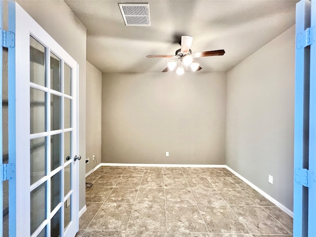 empty room featuring ceiling fan and a textured ceiling