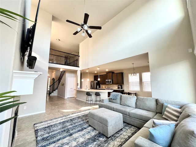 living room featuring a high ceiling and ceiling fan