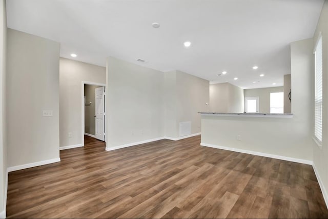 unfurnished living room with dark wood-type flooring