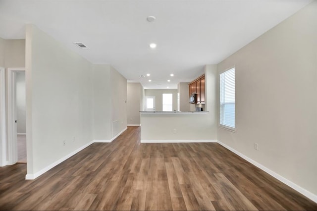 unfurnished living room with dark hardwood / wood-style flooring