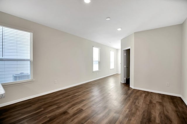 unfurnished room with dark hardwood / wood-style flooring