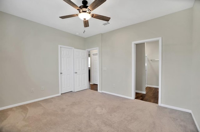 unfurnished bedroom featuring carpet floors and ceiling fan