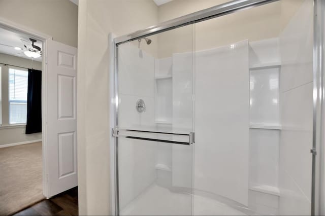 bathroom with ceiling fan and walk in shower