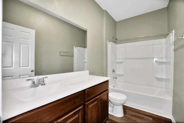 full bathroom with vanity, toilet, bathtub / shower combination, and hardwood / wood-style flooring