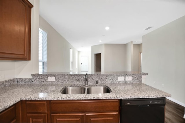 kitchen featuring kitchen peninsula, light stone counters, dishwasher, dark wood-type flooring, and sink