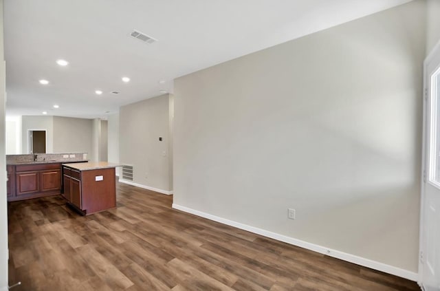 kitchen with a center island, sink, and dark hardwood / wood-style flooring