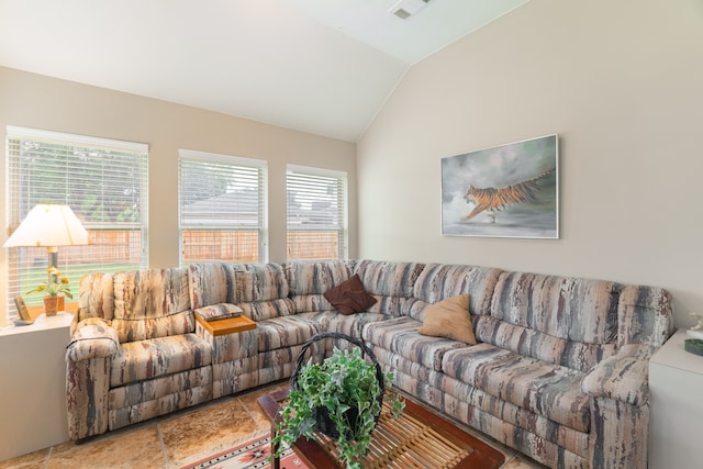 living room featuring vaulted ceiling and a wealth of natural light