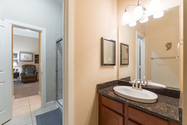 bathroom with vanity, a shower with shower door, and tile patterned flooring