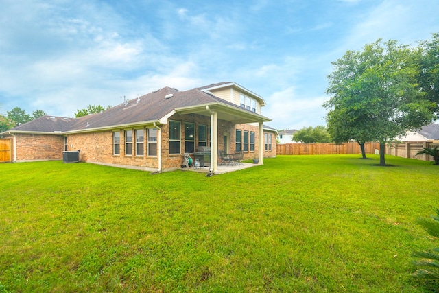 back of property featuring a yard, a patio area, and central AC unit