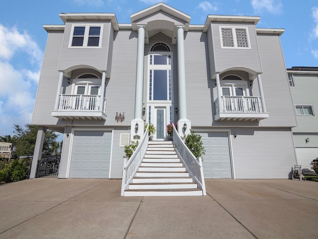 view of property with a balcony and a garage