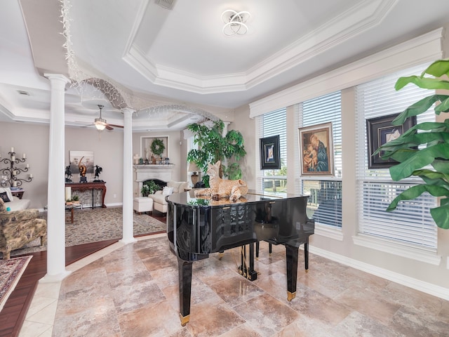 miscellaneous room with ornamental molding, a tray ceiling, ornate columns, and ceiling fan