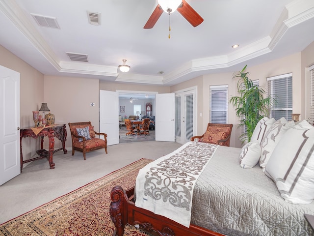 bedroom with ceiling fan, a raised ceiling, carpet, and ornamental molding