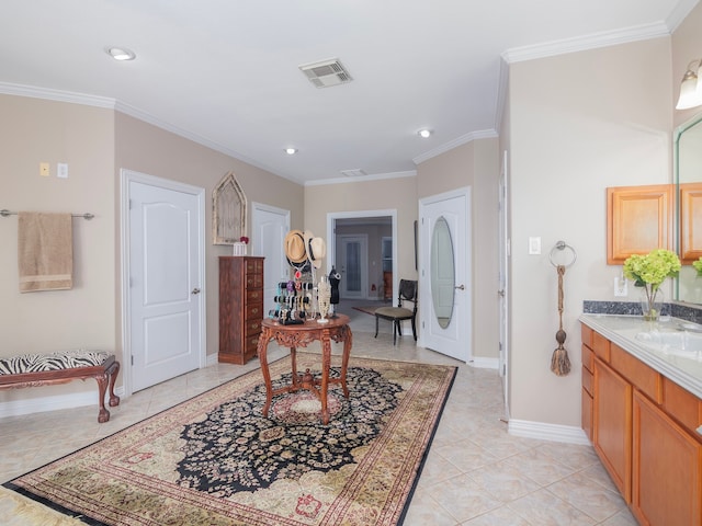 interior space featuring ornamental molding, sink, and light tile patterned floors