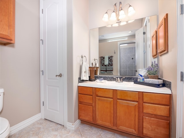 bathroom featuring vanity, toilet, and tile patterned floors