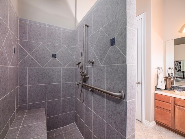 bathroom featuring vanity, tile patterned floors, and tiled shower