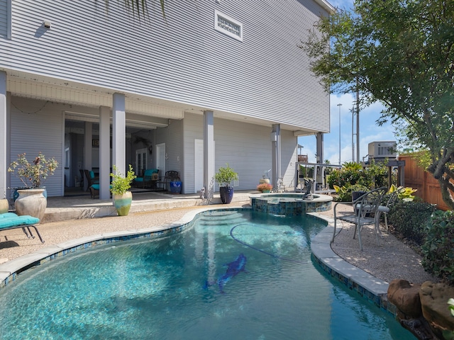 view of pool with a patio area and an in ground hot tub