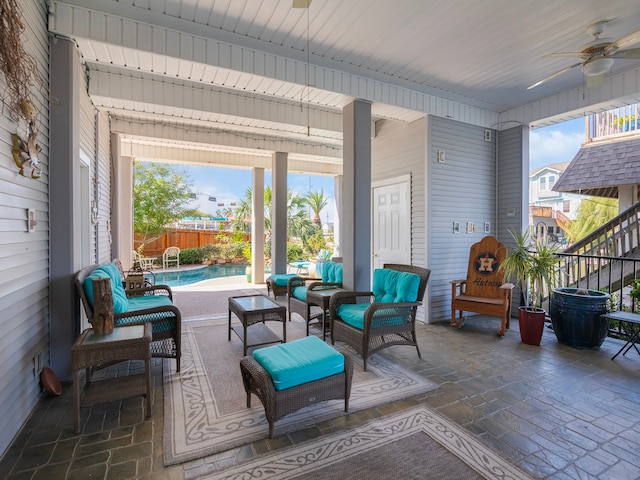 sunroom / solarium with a pool and ceiling fan