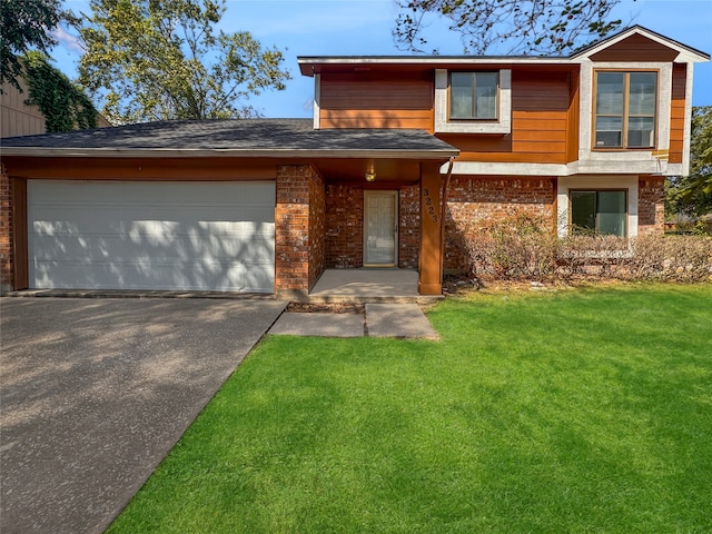 view of front of house with a front yard and a garage