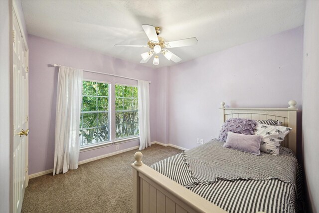 bedroom with carpet floors, ceiling fan, and baseboards