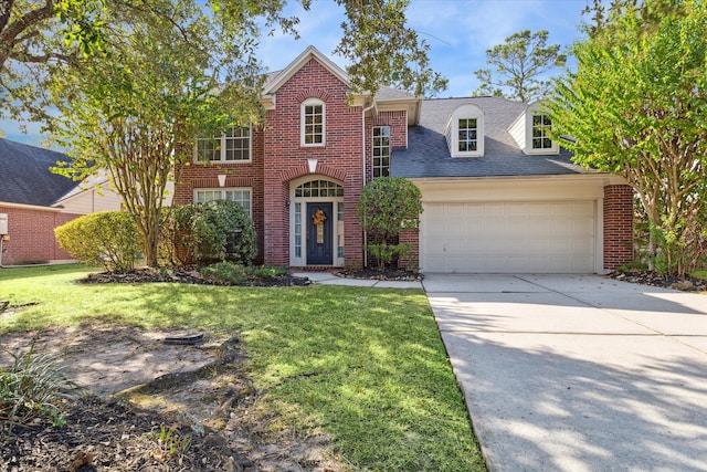 front of property featuring a front yard and a garage