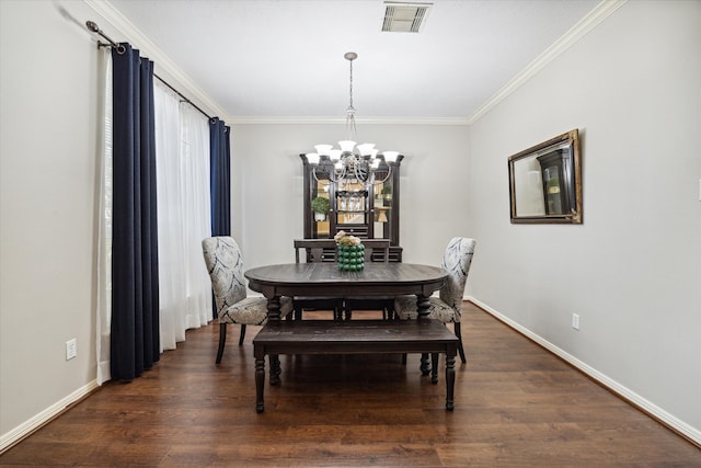 dining room with ornamental molding, an inviting chandelier, and dark hardwood / wood-style floors