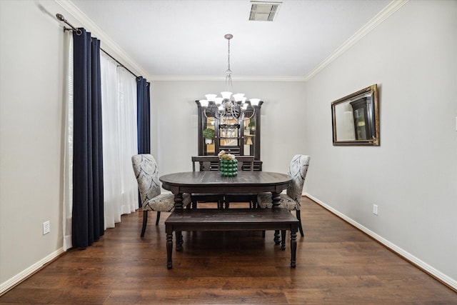 dining space featuring visible vents, crown molding, wood finished floors, baseboards, and an inviting chandelier