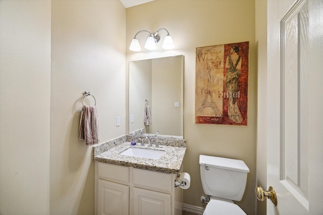 bathroom with toilet and vanity