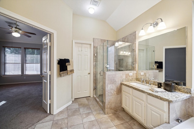 bathroom featuring vaulted ceiling, tile patterned floors, vanity, ceiling fan, and an enclosed shower