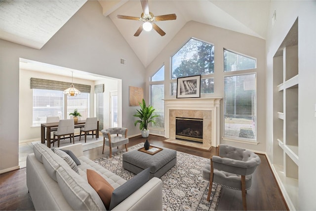 living room featuring ceiling fan, visible vents, wood finished floors, high vaulted ceiling, and baseboards