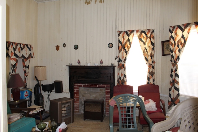 sitting room with a brick fireplace