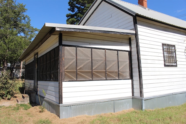 view of property exterior featuring a sunroom