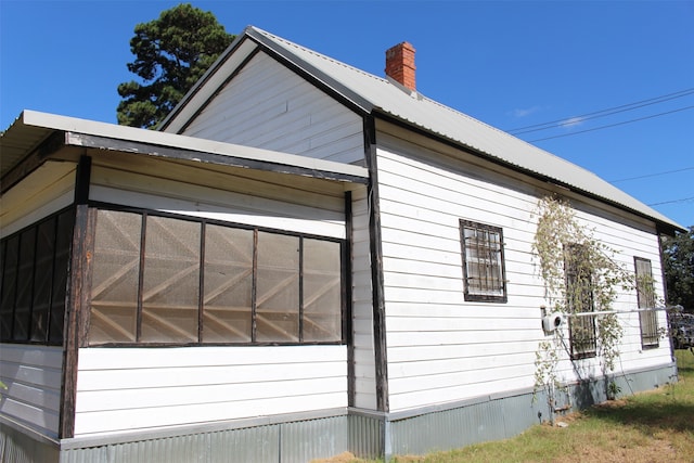 view of side of home with a sunroom