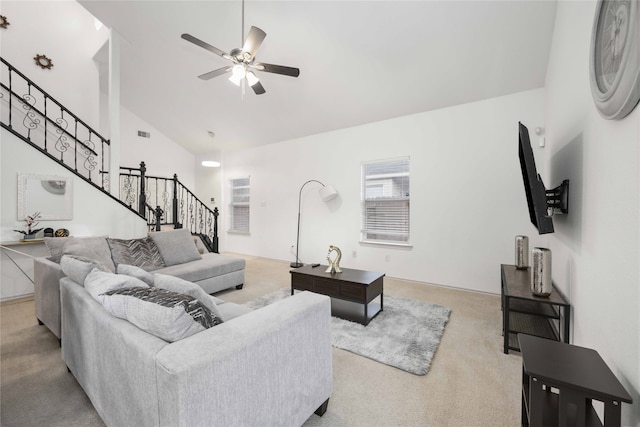 carpeted living room with high vaulted ceiling and ceiling fan