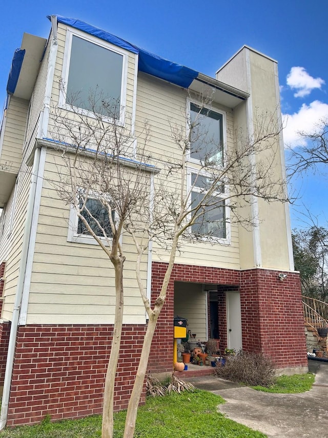 view of front of house featuring brick siding