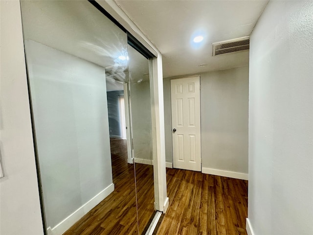 hallway with dark hardwood / wood-style floors