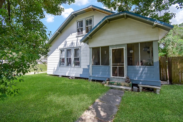 bungalow-style house with a front lawn