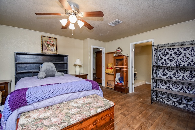 bedroom with hardwood / wood-style floors, a textured ceiling, and ceiling fan