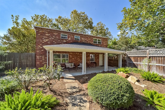 back of property featuring a patio area, a fenced backyard, and brick siding