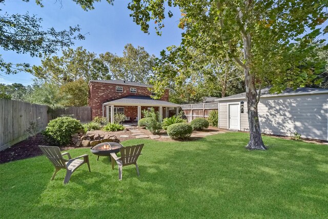 view of yard featuring a fire pit and a patio area