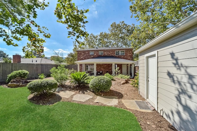 view of yard with an outbuilding and fence