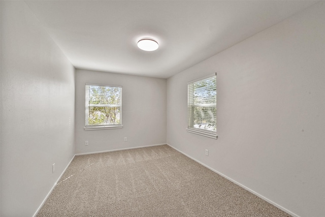 empty room with light carpet and baseboards